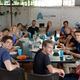 Happy people sitting around the table in coworking space
