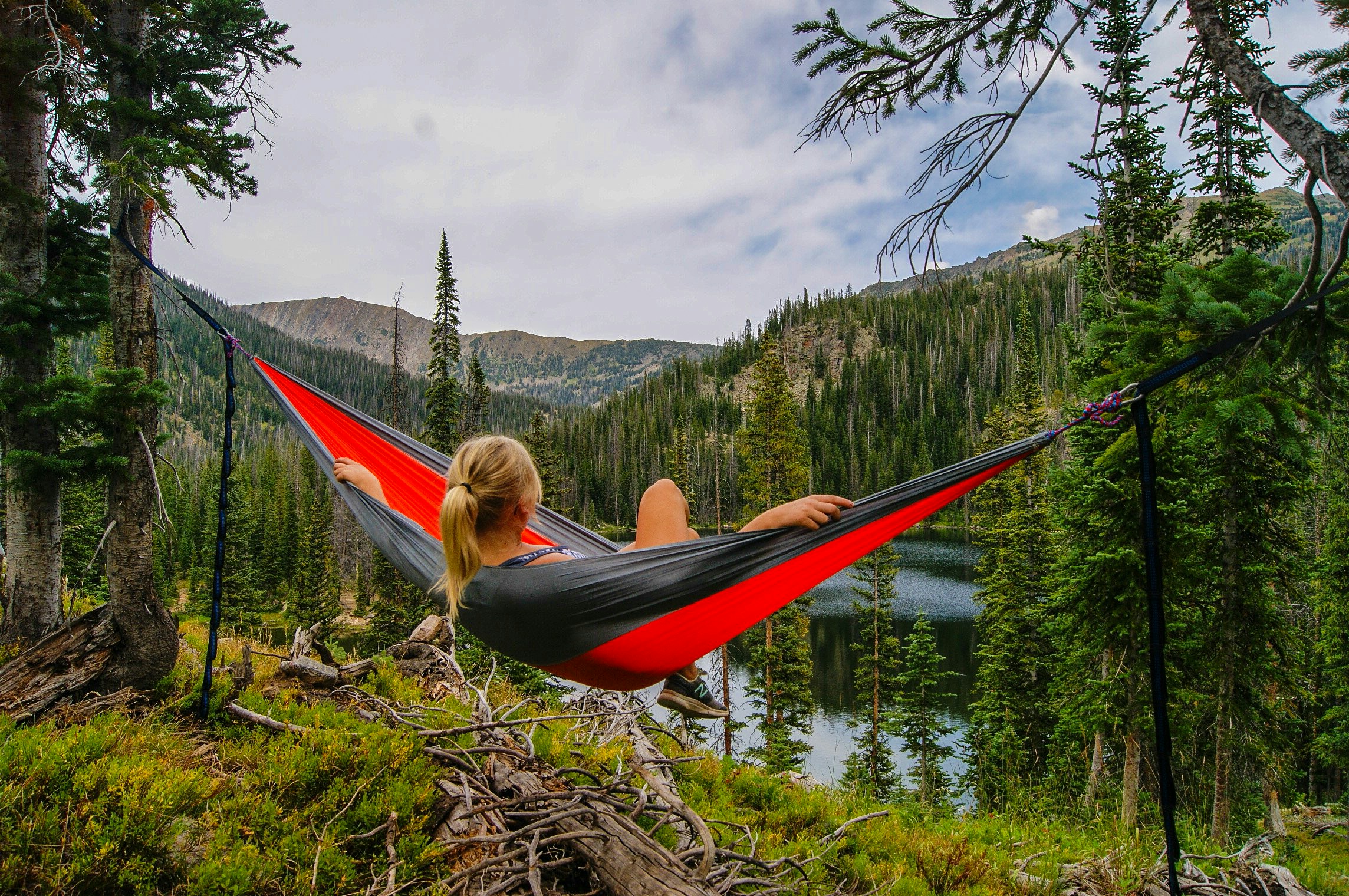 The woman is lying on a hammock