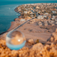 crystal ball looking over city beach