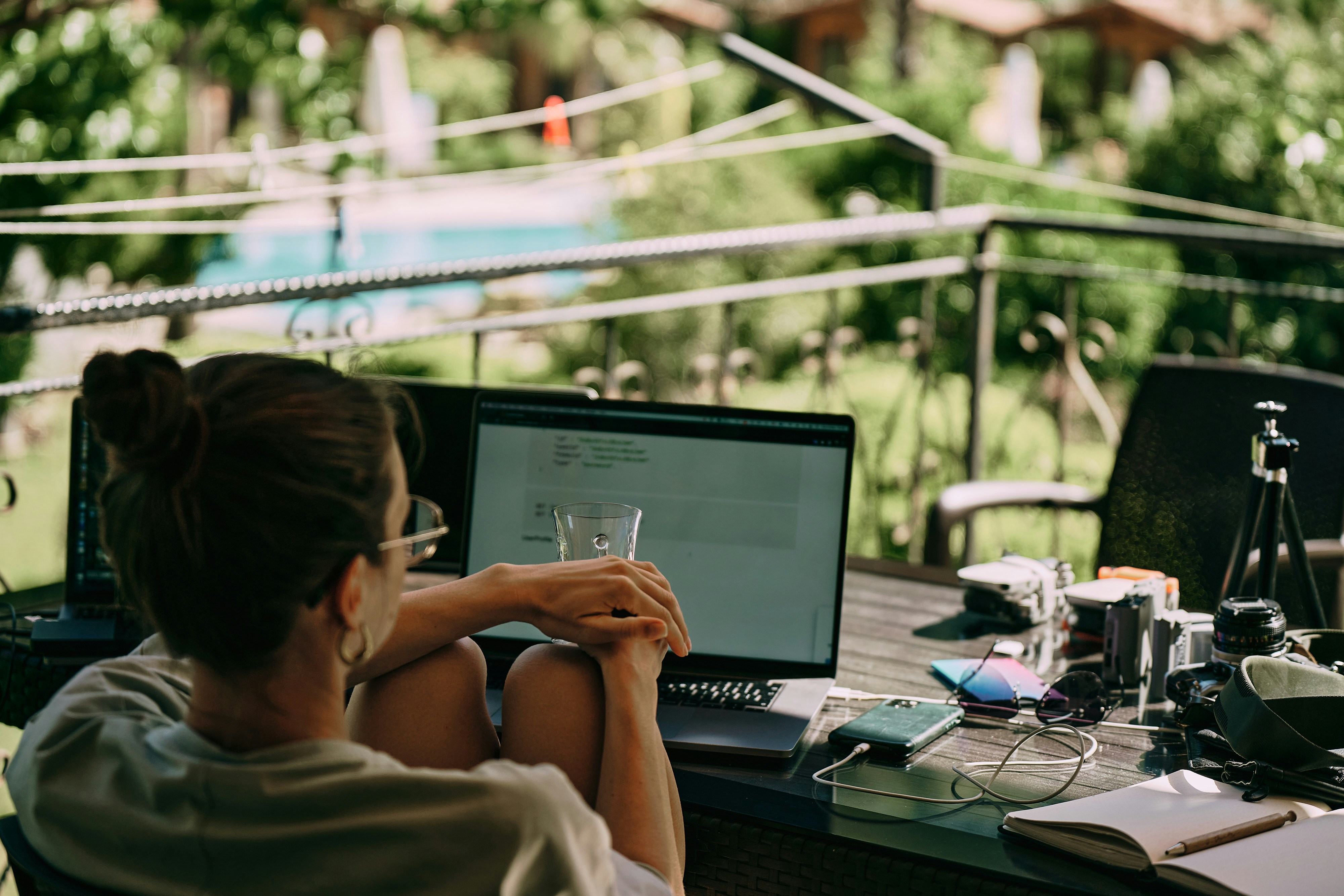A woman is looking at a laptop