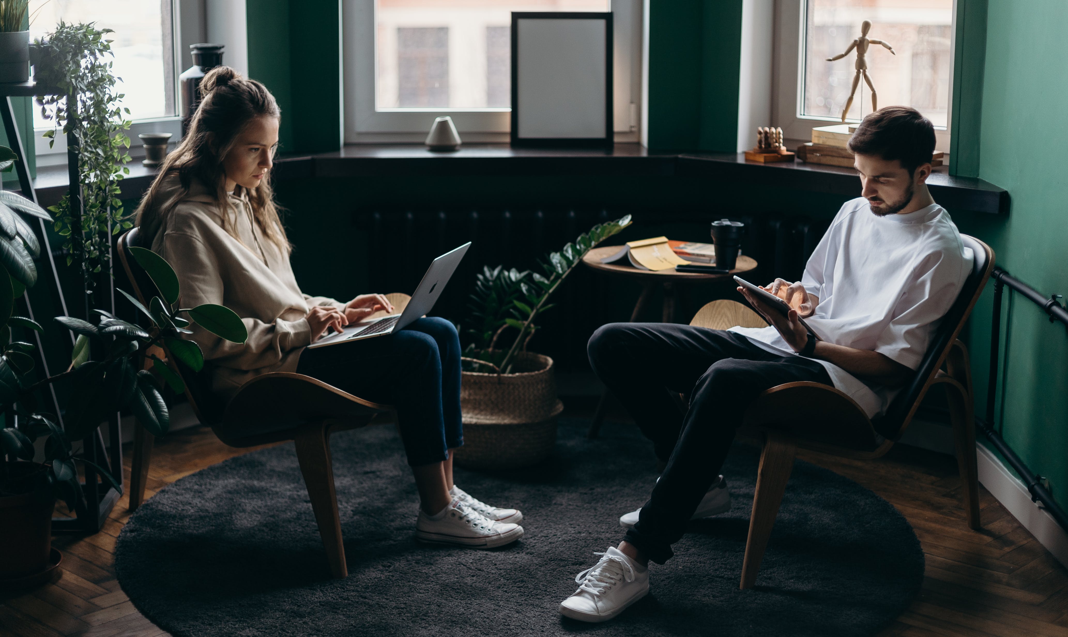 A man and a woman are looking at the laptop