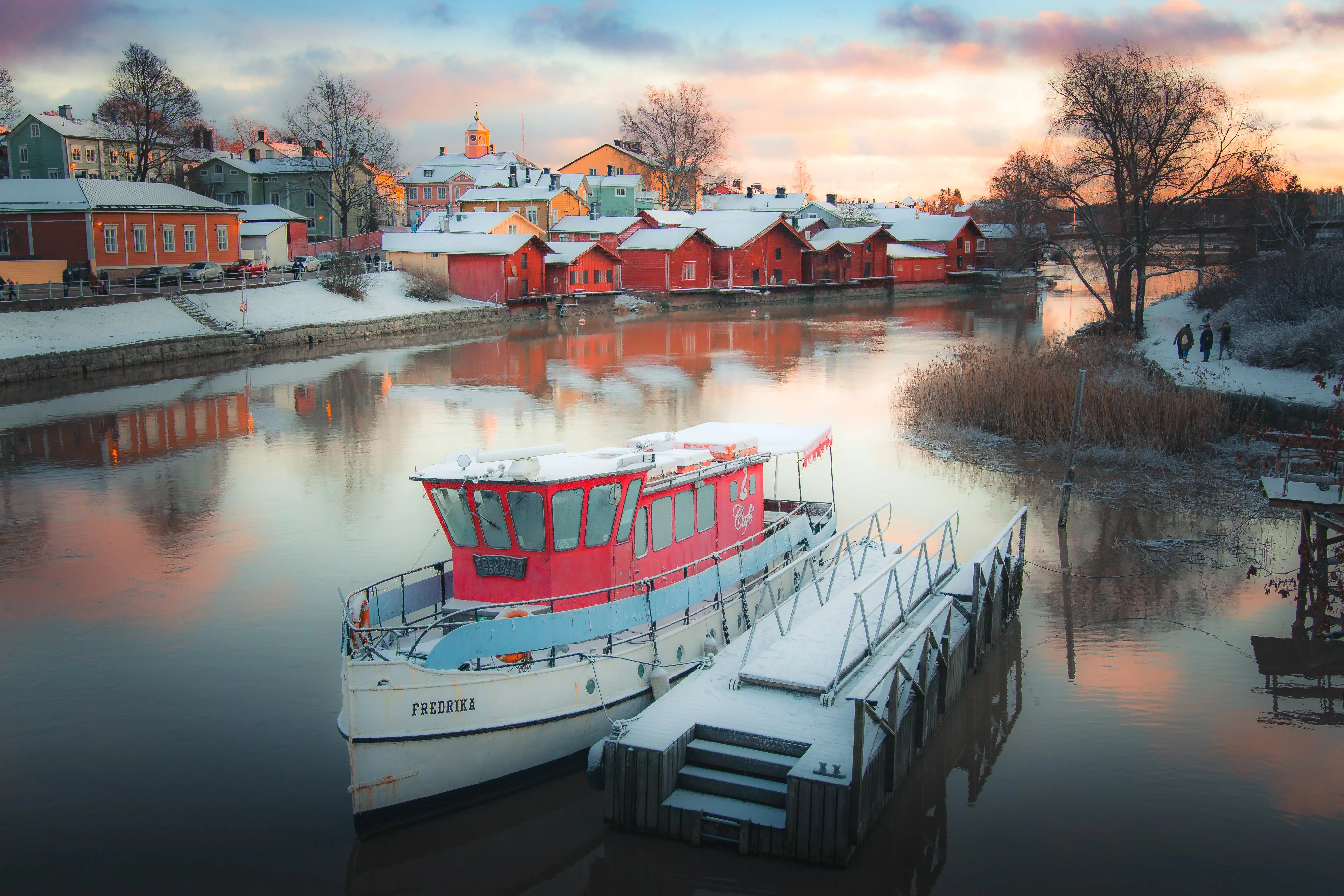 Finland river with boat and houses in snow