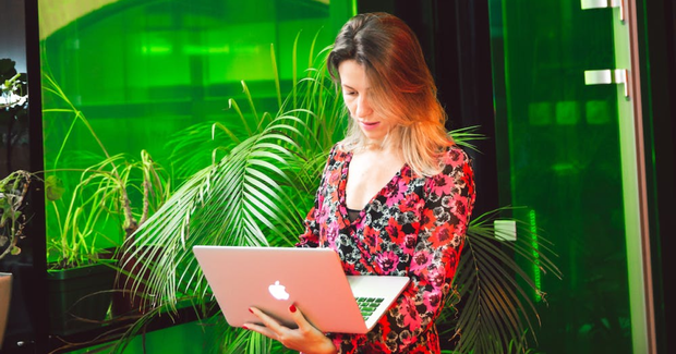 worker filling out documents on laptop