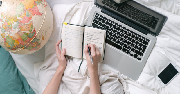 someone writing in a notebook