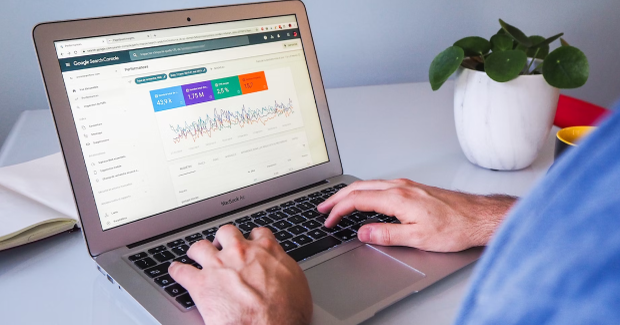 The man is looking at the laptop