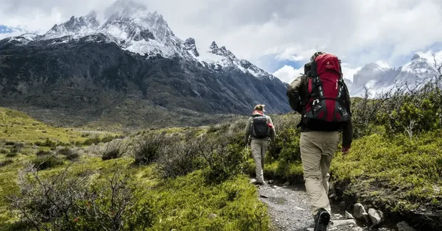 backpackers hiking up a mountain