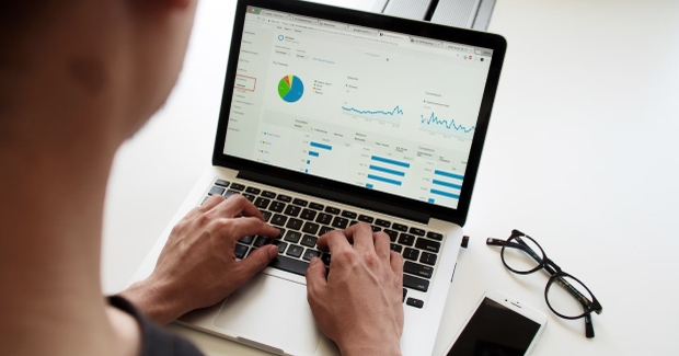 The man is looking at the laptop