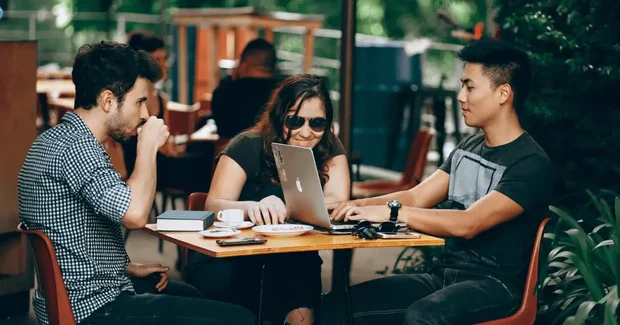 group working outside on computer
