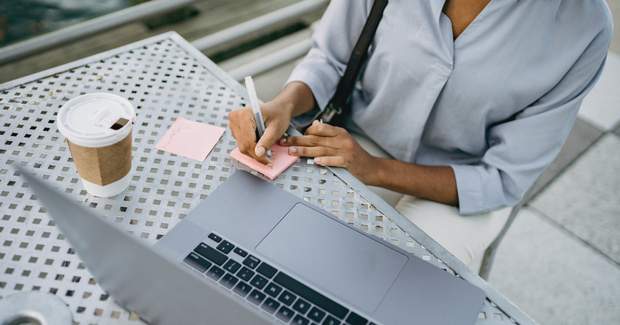 person writing at a table