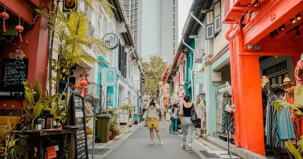 guy taking a photo in a colorful street