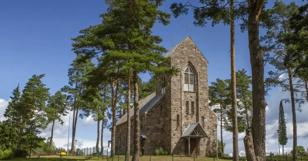 Lithuania old church with tall trees