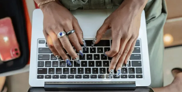 girl typing with pretty finger nails