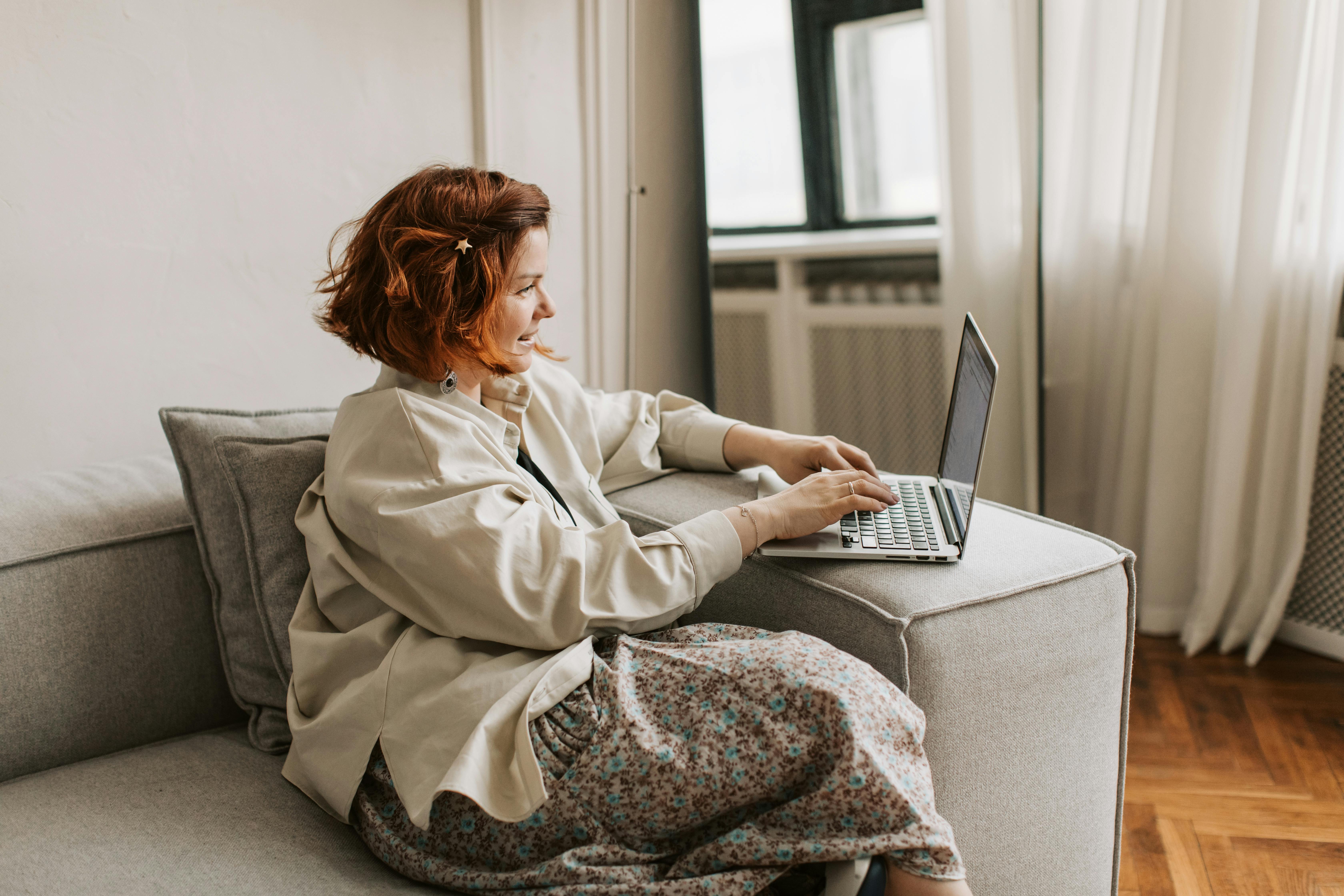 A woman on the couch with a laptop
